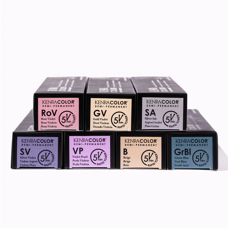 Seven Kenra Color Demi-Permanent Rapid Toner boxes stacked in a pyramid arrangement against a white background, displaying shades including Rose Violet, Gold Violet, Silver Ash, Silver Violet, Violet Pearl, Beige, and Green Blue. Featured image for blog p