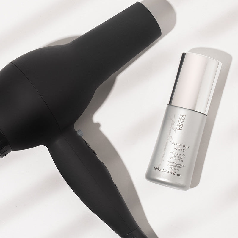 A sleek black blow dryer is shown beside a slim silver cylindrical styling product against a light gray background. Featured image for blog post: Top 3 Products You Can’t Go Without This Holiday Season