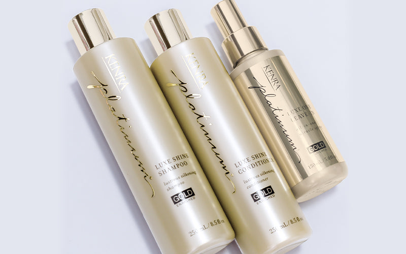 Three Kenra Professional gold-toned conditioner bottles arranged together on a light surface in a clean product shot. Featured image for blog post: What Are the Benefits of Hair Conditioner? Here's Why You Should Use It and How Often