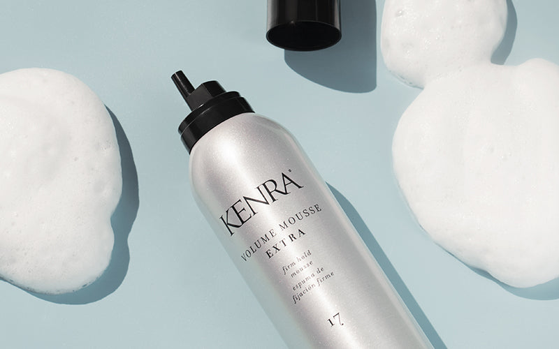 A sleek white Kenra Professional mousse bottle with a cloud of white foam resting beside it on a light blue background. Featured image for blog post: Our Best Mousse for Fine Hair Pairs Great With This Irish Coffee Whiskey Cocktail: Get Sassy With the Vol