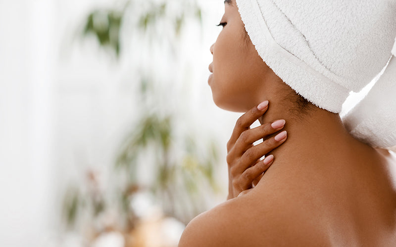 A side profile of a woman with light skin, eyes closed and face tilted upward in a calm, peaceful pose against a soft white background with blurred greenery. Featured image for blog post: Say Yes to Self-Care for Your Hair
